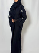 abaya noire Nejma vue de face fluide en nidha auc manches travaillées et brodée